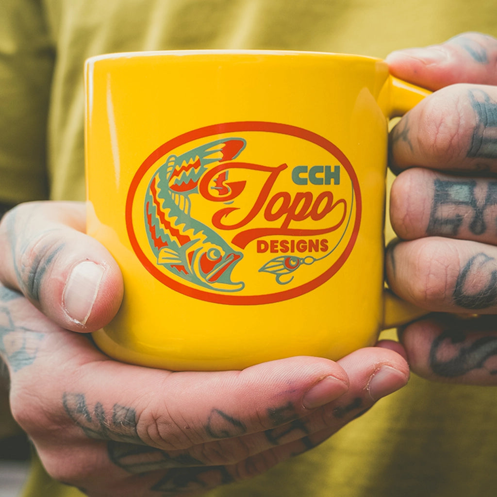 Outside detail shot of Topo Designs x CCH x Pine Printshop Mug - 14 oz in "Minolo Yellow"