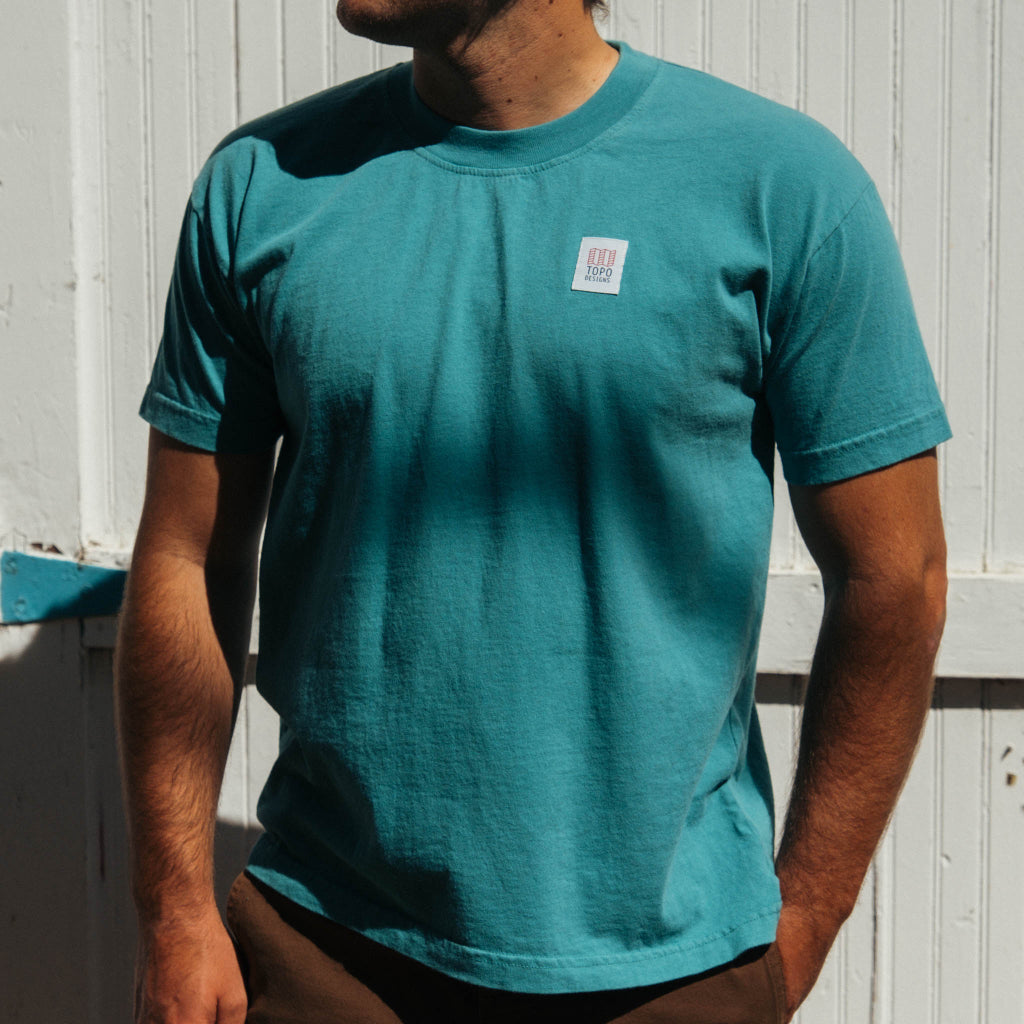 Front lifestyle image of Topo Designs x Soft Goods Label Tee in "Alpine Teal"
