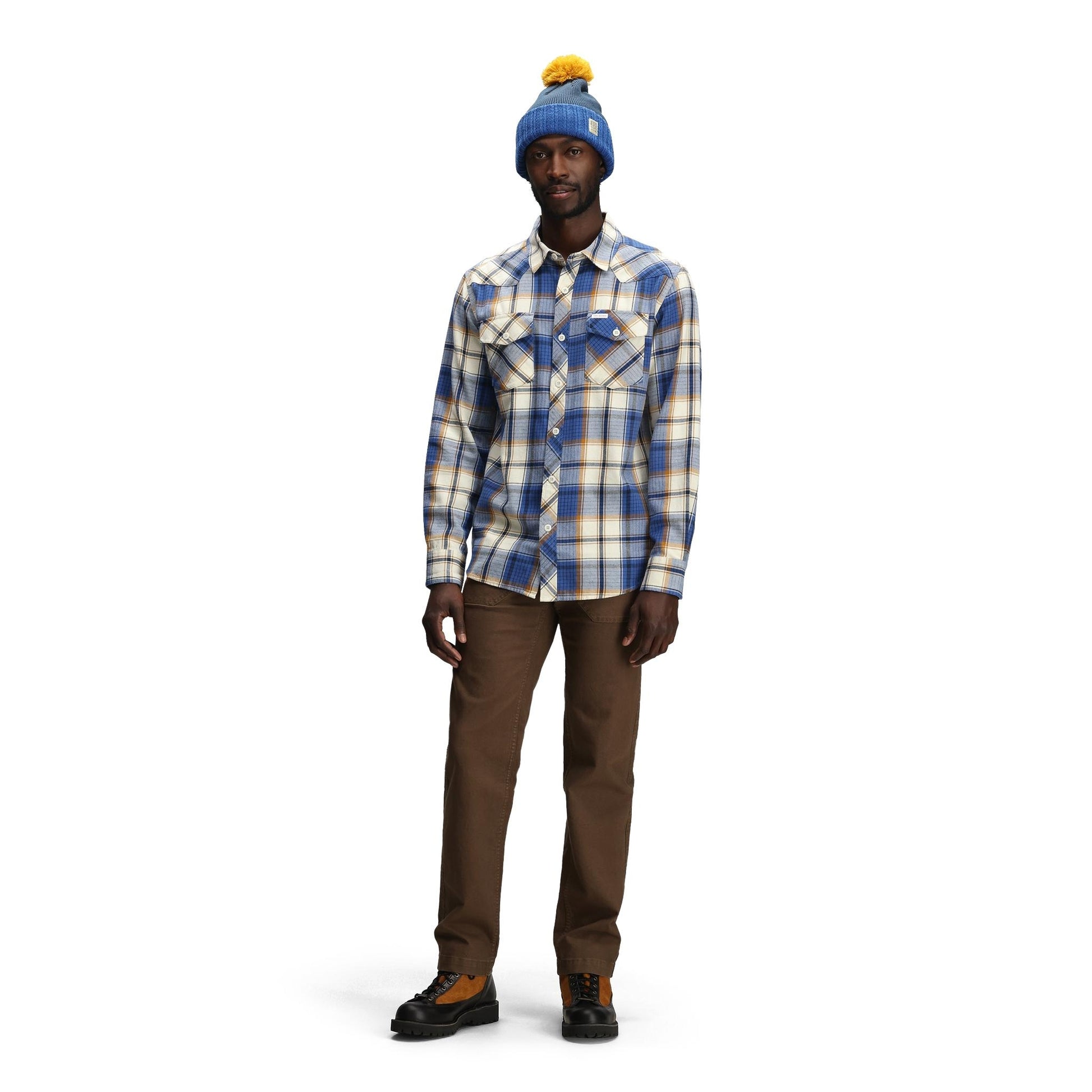 General front model shot of Topo Designs Pompom Beanie in "Cobalt / Midnight"