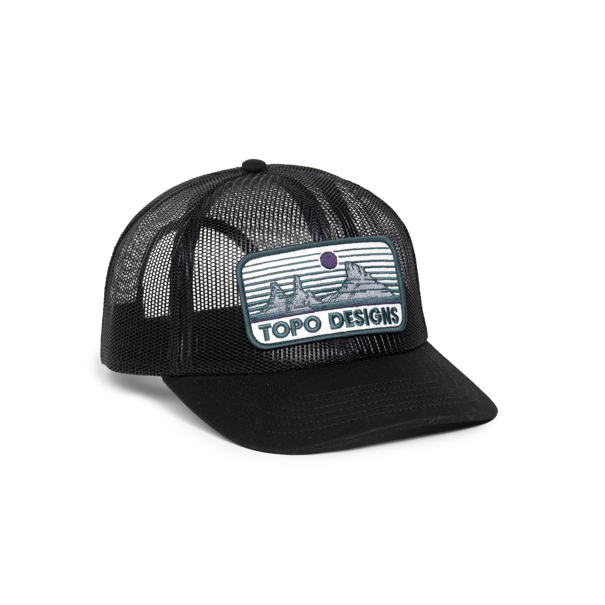 Front white background quarter image of Topo Designs Patch Mesh Trucker - Desert Dusk in "Black"