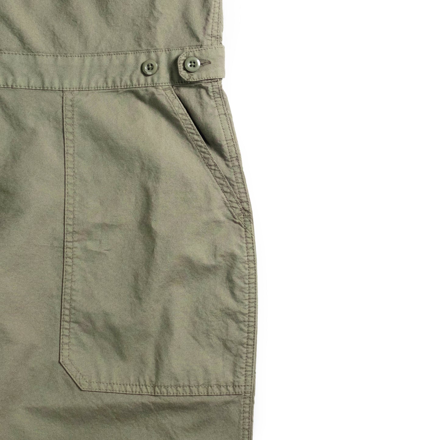Front pocket detail white background flat lay image of Topo Designs Desert Coverall - Women's in "Beetle"