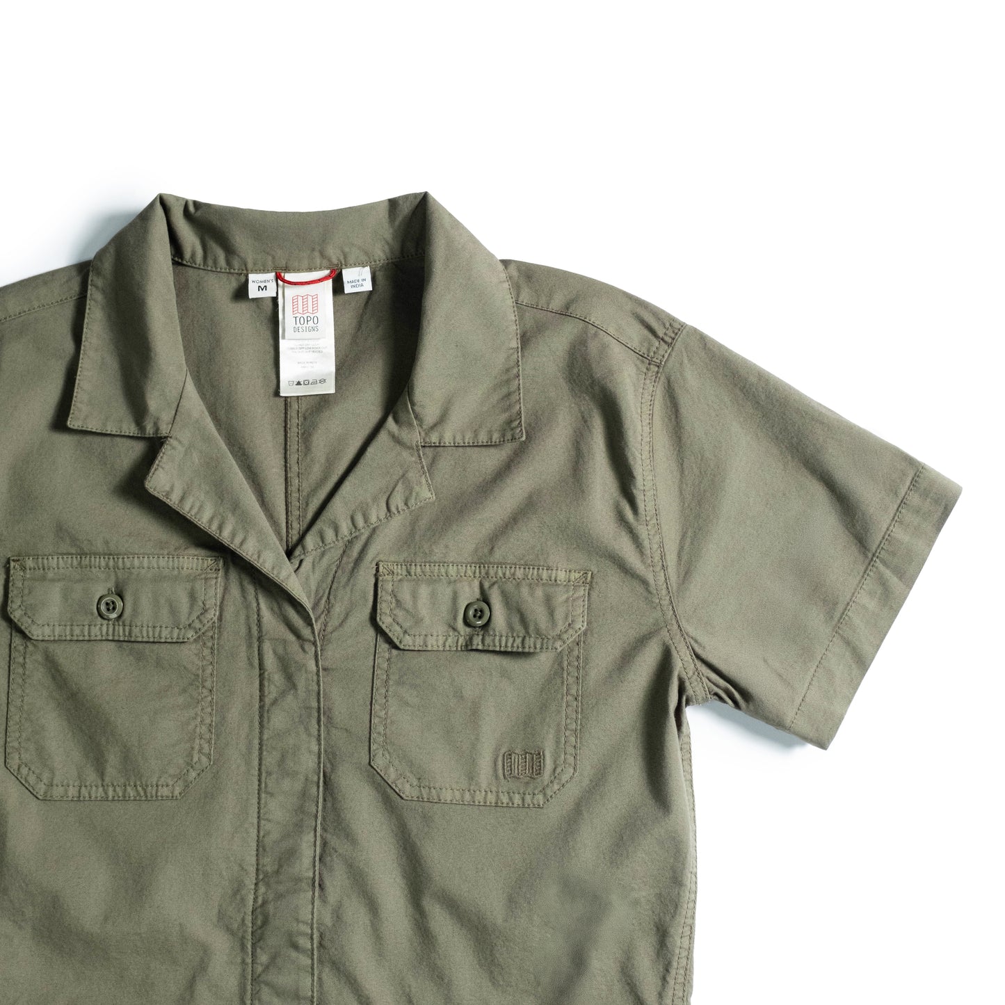 Front detail white background flat lay image of Topo Designs Desert Coverall - Women's in "Beetle"