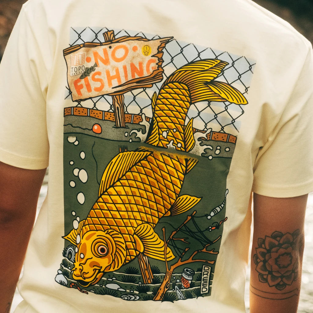 Lifestyle shot of Topo Designs x CCH x Pine Printshop Urban Angler Tee in "Butter"