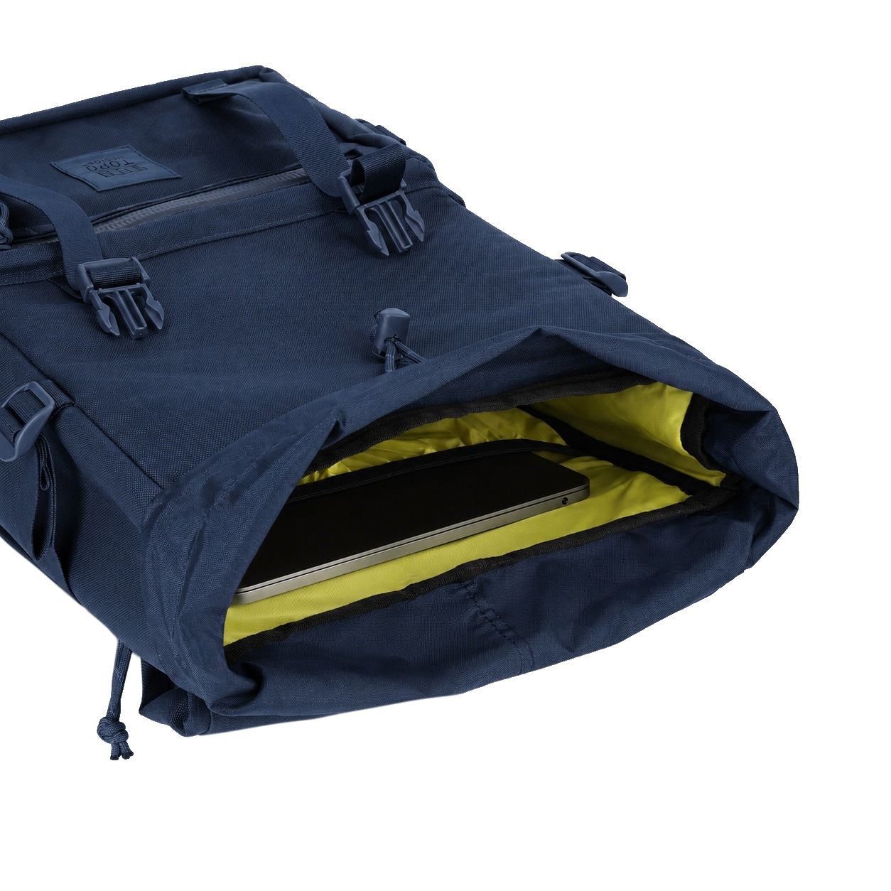 General detail Shot of the Topo Designs Rover Pack Tech in "Navy" showing yellow inside and laptop sleeve